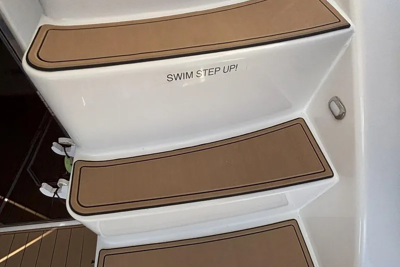 Slide: The Image of Steps on a 2008 Sea Ray 47 Sedan Bridge with "Swim Step Up!" text. - 27