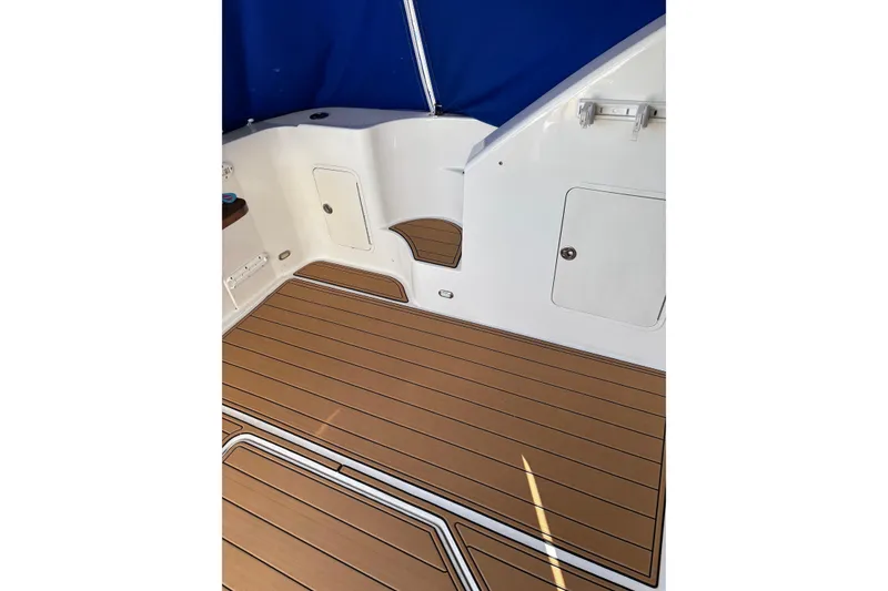 Slide: The Image of 2008 Sea Ray 47 Sedan Bridge deck with wood finish and blue canopy. - 30