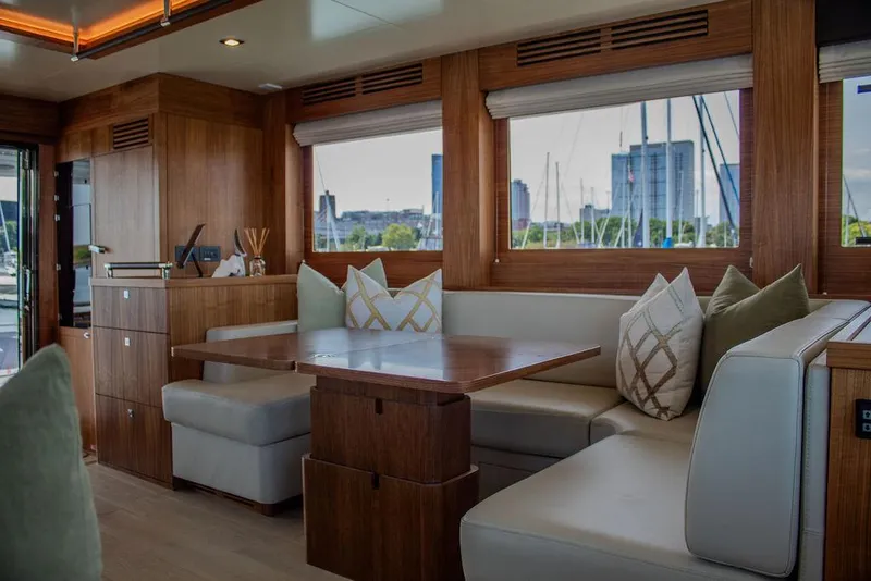 Slide: The Image of Luxurious interior of 2022 Sirena 58 Flybridge yacht with elegant wood finish and plush seating. - 10