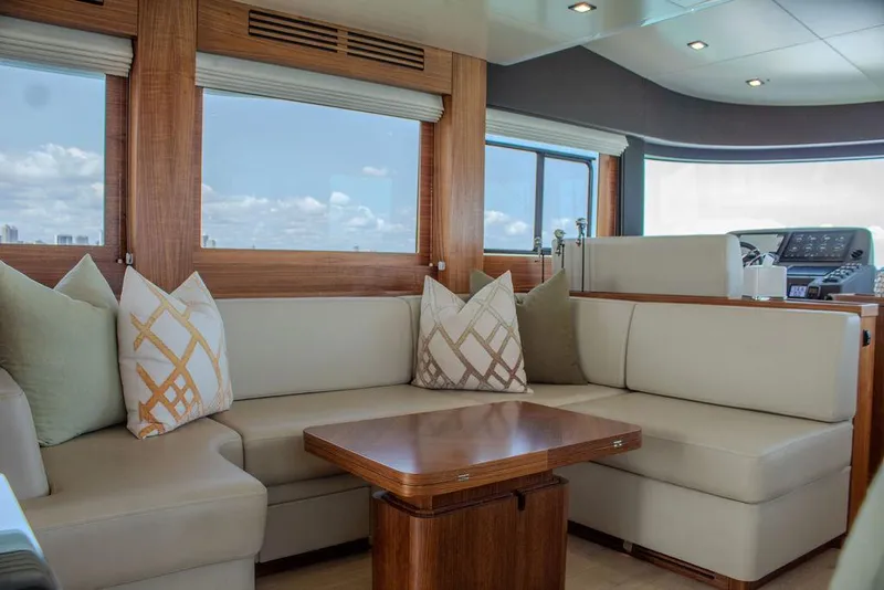 Slide: The Image of Luxurious interior of 2022 Sirena 58 Flybridge yacht with elegant seating and wooden accents. - 11