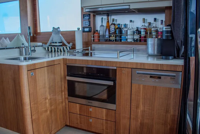 Slide: The Image of Modern kitchen in 2022 Sirena 58 Flybridge yacht with wood cabinetry and appliances. - 12