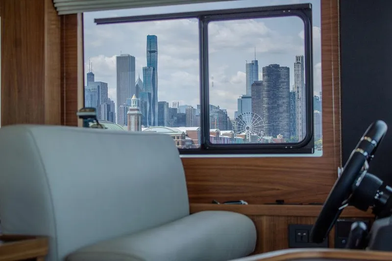 Slide: The Image of Interior of 2022 Sirena 58 Flybridge yacht with city skyline view through window. - 15