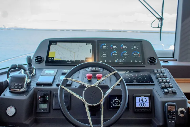 Slide: The Image of Sirena 58 Flybridge 2022 yacht helm with advanced navigation displays and controls. - 17