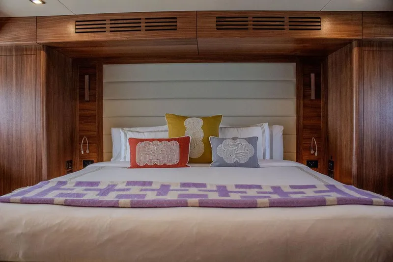 Slide: The Image of Luxurious bedroom interior of 2022 Sirena 58 Flybridge yacht with colorful pillows. - 19