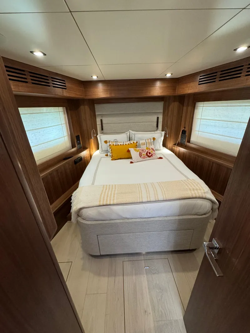 Slide: The Image of Luxurious cabin interior of 2022 Sirena 58 Flybridge yacht with cozy bed and elegant wood finish. - 3