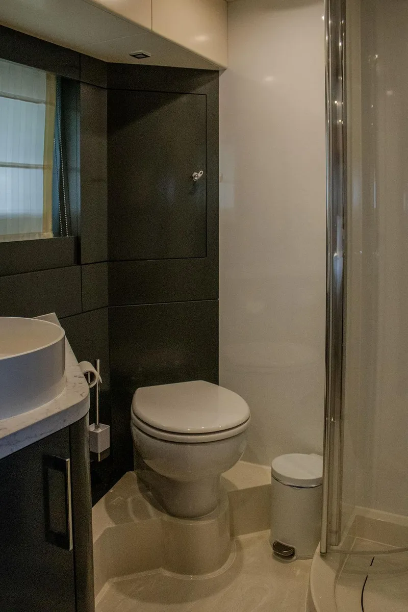 Slide: The Image of Luxurious bathroom in 2022 Sirena 58 Flybridge yacht with modern fixtures and elegant design. - 30