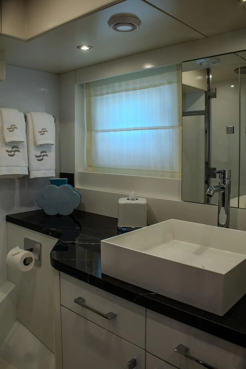 Slide: The Image of Luxurious bathroom in 2022 Sirena 58 Flybridge yacht with modern sink and elegant decor. - 31