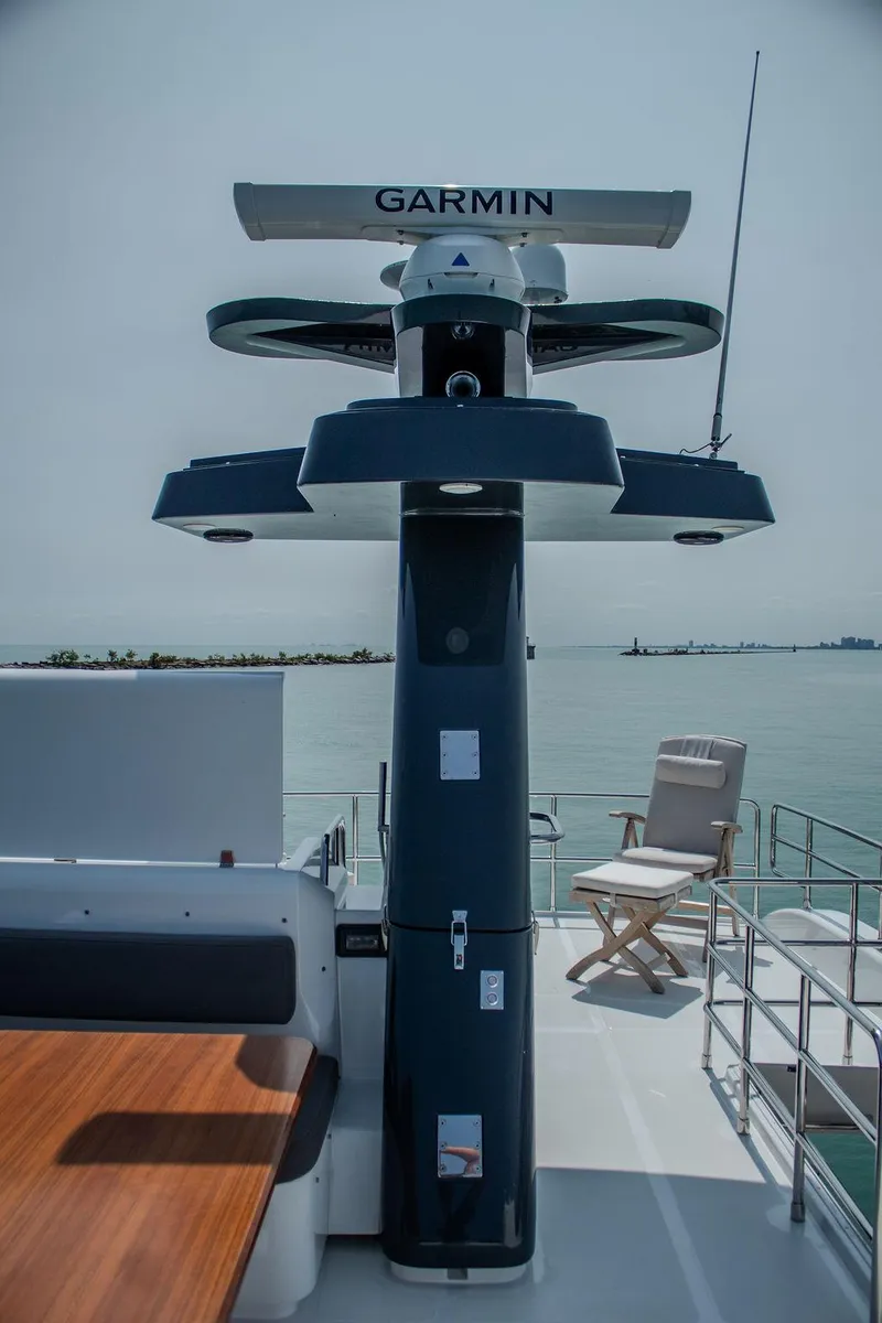 Slide: The Image of Sirena 58 Flybridge 2022 yacht with Garmin radar, elegant deck seating, and ocean view. - 37