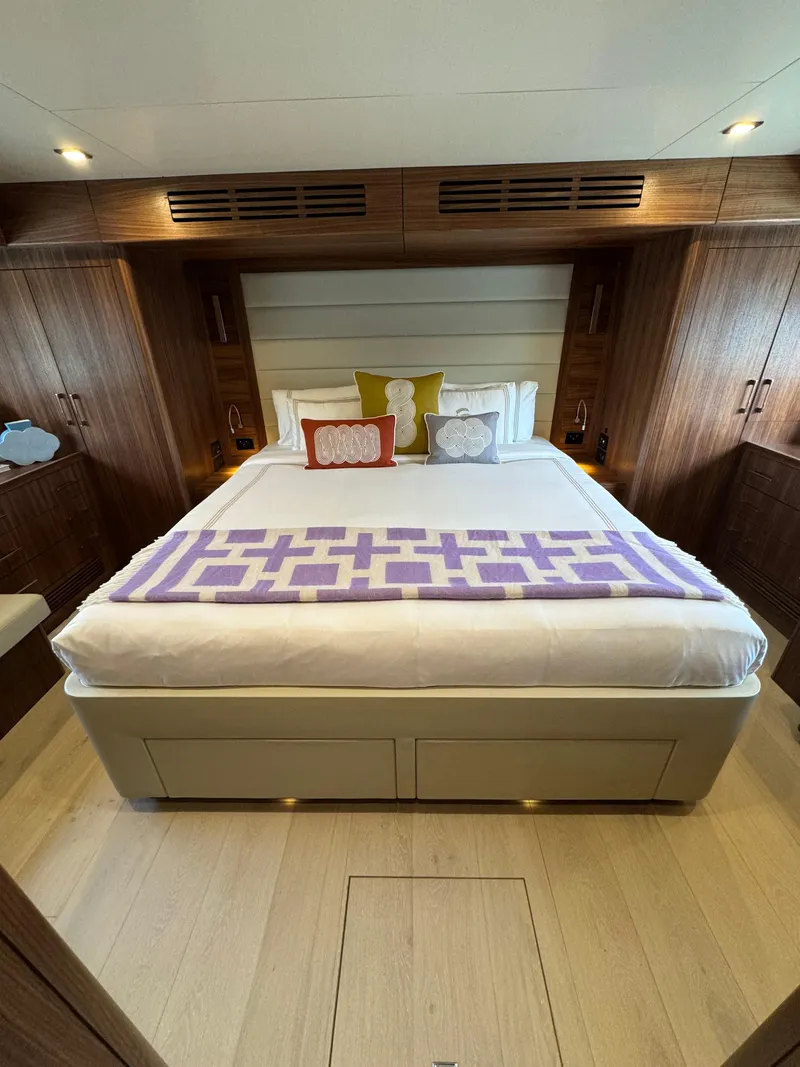 Slide: The Image of Luxurious bedroom interior of 2022 Sirena 58 Flybridge yacht with elegant wood finishes. - 4