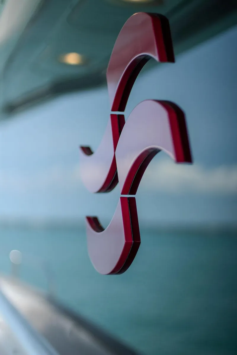 Slide: The Image of Red logo on Sirena 58 Flybridge yacht, 2022 model, with ocean background. - 45