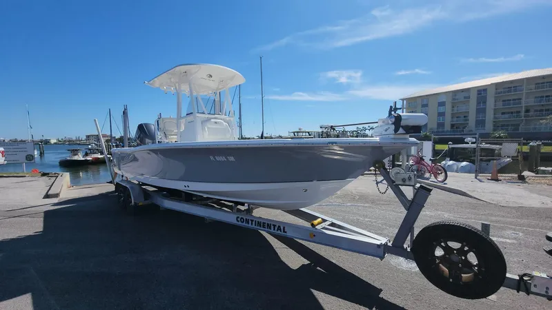Slide: The Image of 2020 Sea Hunt BX 25 BR boat on trailer at marina under clear sky. - 12