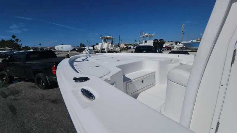 Slide: The Image of 2020 Sea Hunt BX 25 BR boat in marina, clear sky background. - 13
