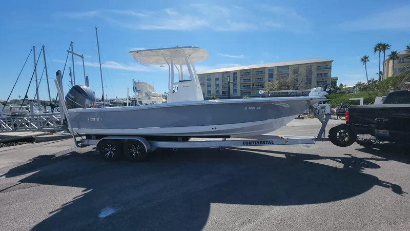 Slide: The Image of 2020 Sea Hunt BX 25 BR boat on trailer at marina under clear sky. - 14