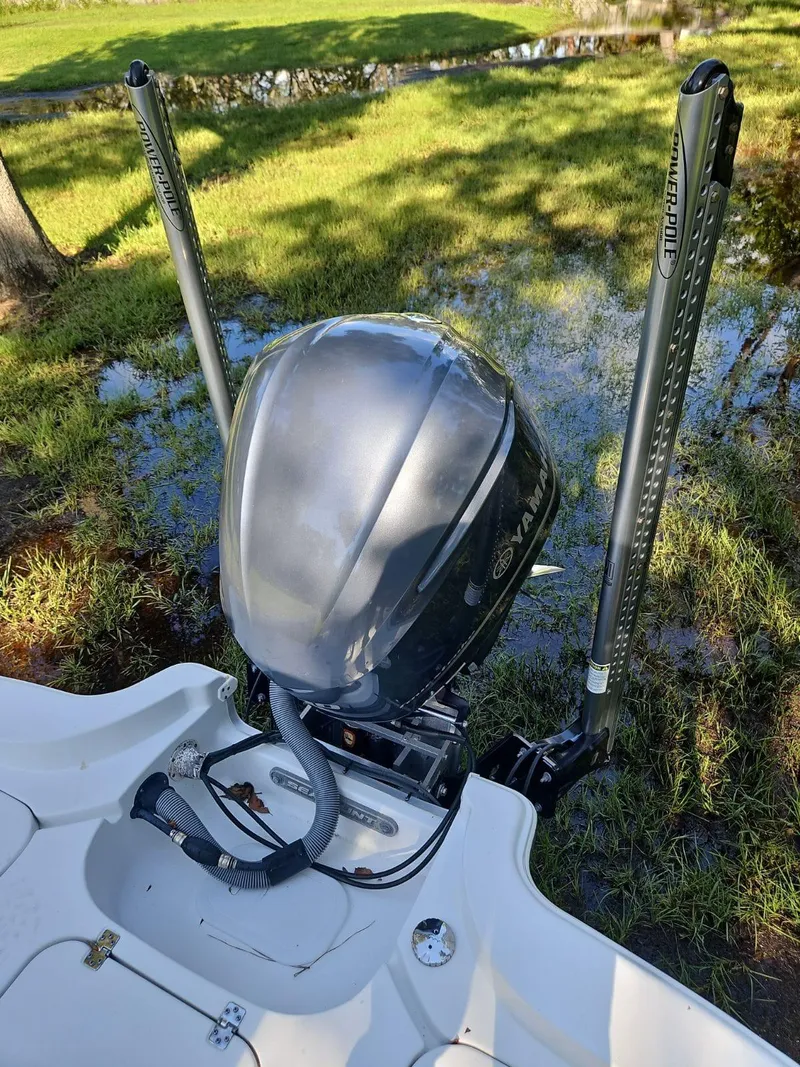 Slide: The Image of 2020 Sea Hunt BX 25 BR boat engine with dual power poles in grassy area. - 17