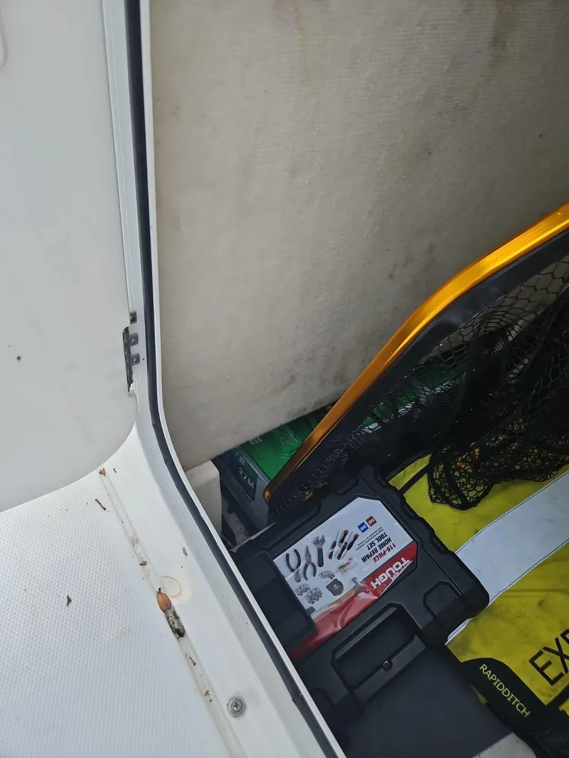 Slide: The Image of Storage compartment of 2020 Sea Hunt BX 25 BR boat with fishing gear and tools. - 25