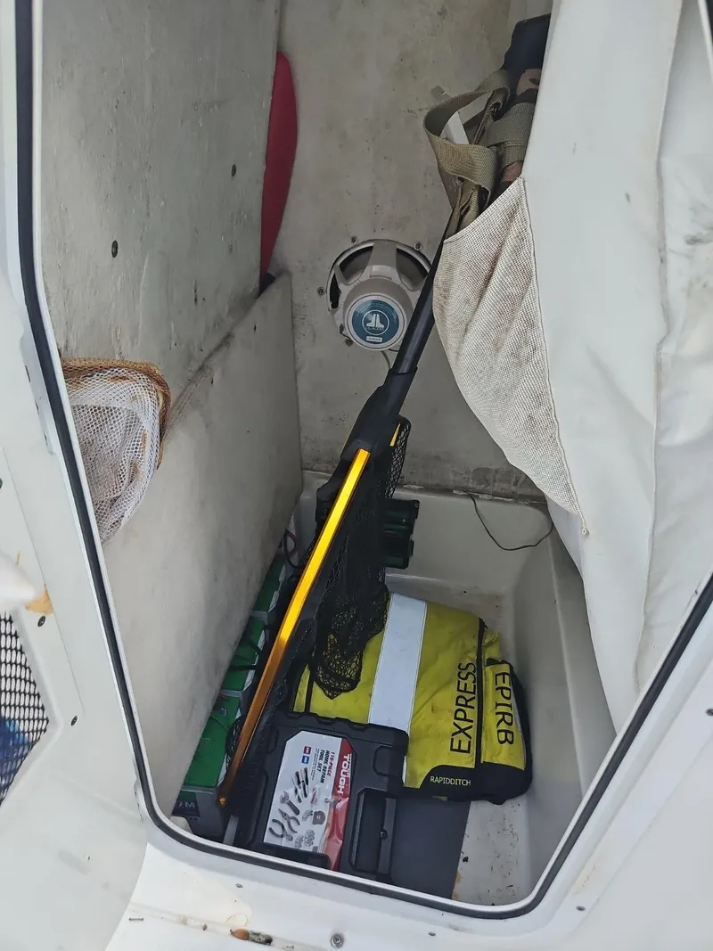 Slide: The Image of Storage compartment in a 2020 Sea Hunt BX 25 BR boat with fishing gear and supplies. - 27