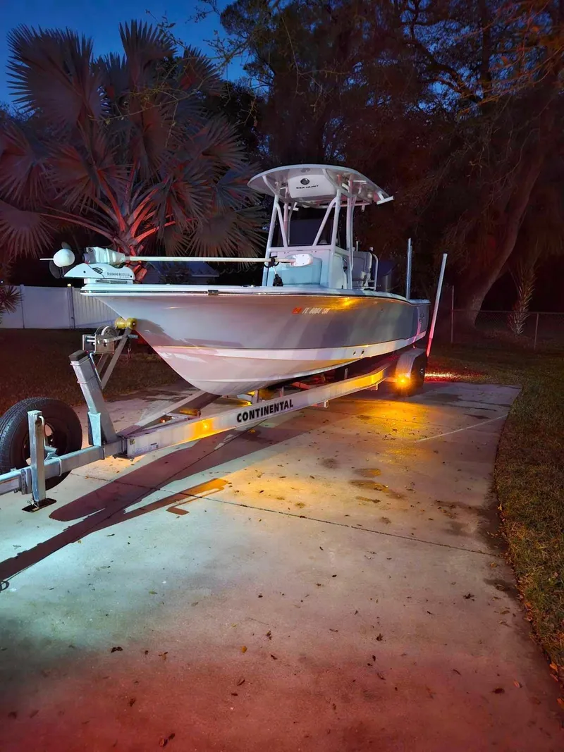 Slide: The Image of 2020 Sea Hunt BX 25 BR boat on trailer, illuminated at dusk. - 28