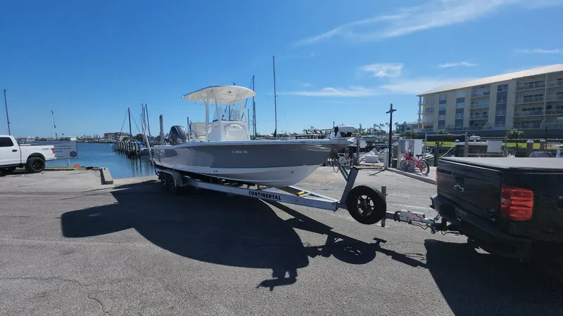 Slide: The Image of 2020 Sea Hunt BX 25 BR boat on trailer at marina, sunny day. - 30