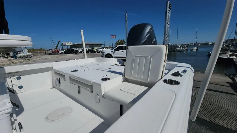 Slide: The Image of 2020 Sea Hunt BX 25 BR boat interior at marina, featuring seating and storage. - 31