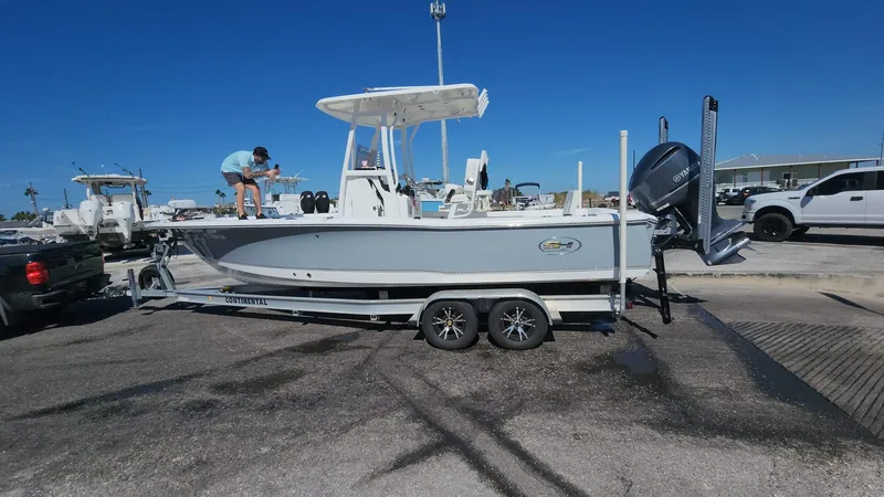 Slide: The Image of 2020 Sea Hunt BX 25 BR boat on trailer at marina under clear blue sky. - 32