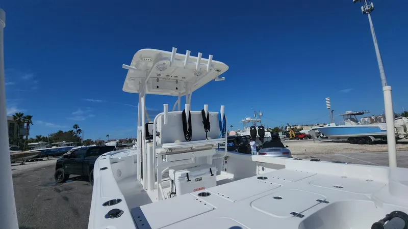 Slide: The Image of 2020 Sea Hunt BX 25 BR boat with T-top, parked outdoors under clear blue sky. - 37