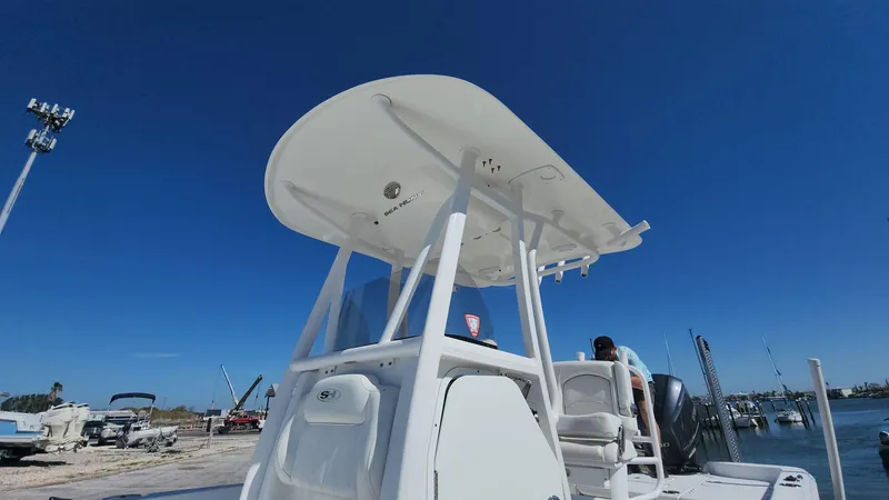 Slide: The Image of 2020 Sea Hunt BX 25 BR boat with T-top, docked under clear blue sky. - 48