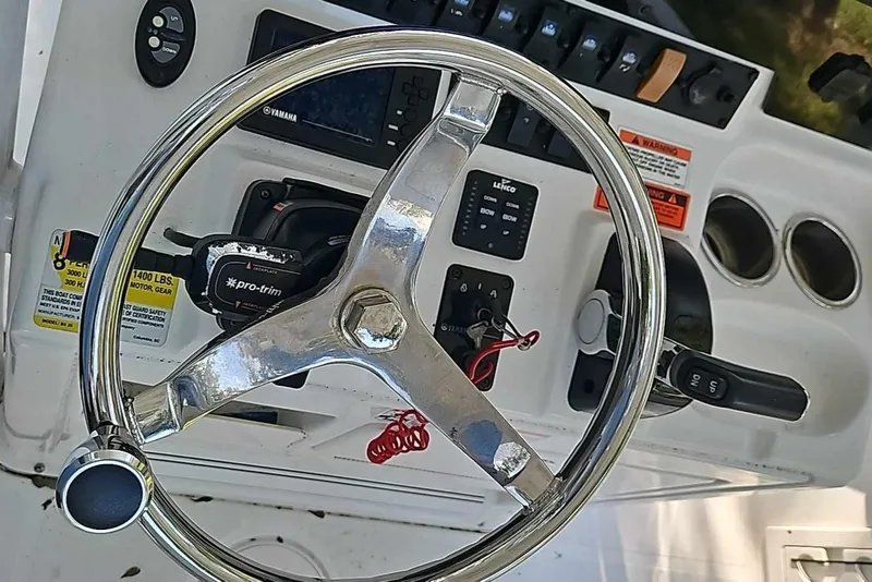 Slide: The Image of 2020 Sea Hunt BX 25 BR boat dashboard with steering wheel and controls. - 5