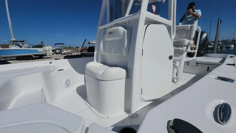 Slide: The Image of 2020 Sea Hunt BX 25 BR boat interior with seating and console, docked at marina. - 9