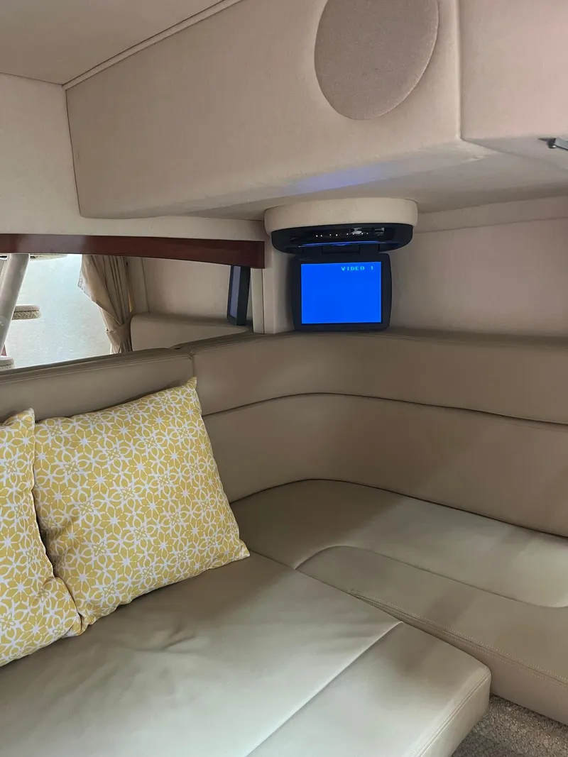 Slide: The Image of Interior of 2006 Sea Ray 320 Sundancer with beige seating and decorative pillows. - 8