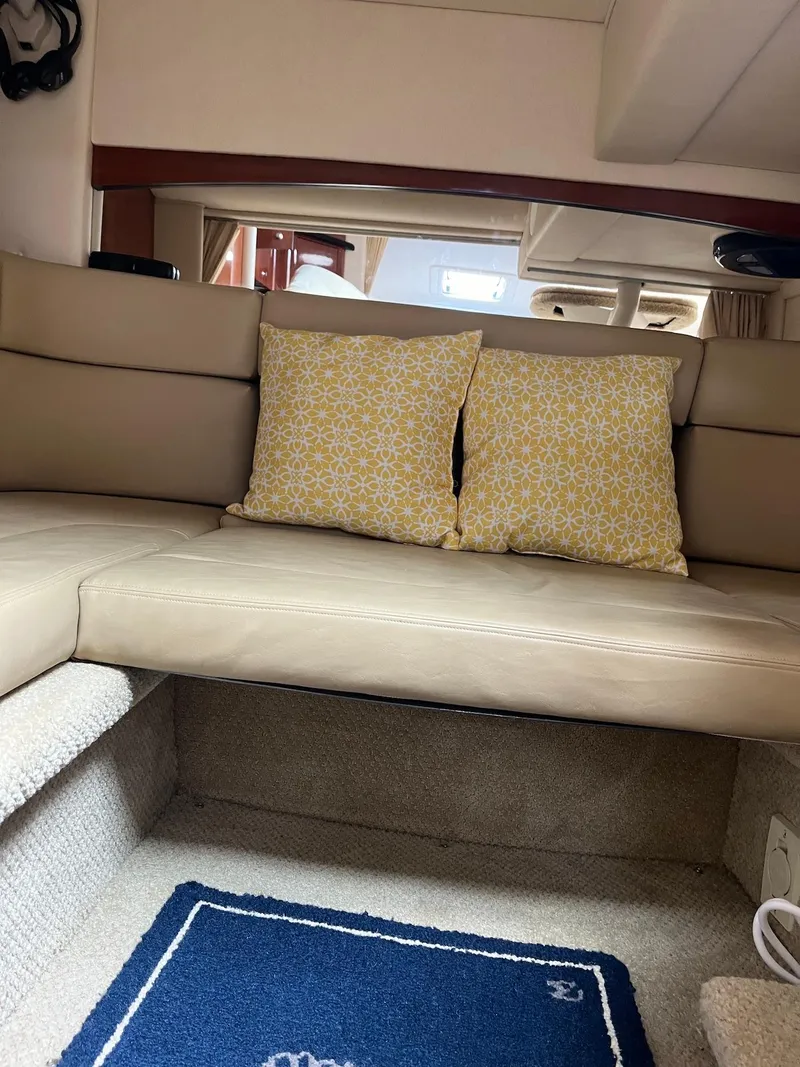 Slide: The Image of Interior of 2006 Sea Ray 320 Sundancer with beige seating and decorative pillows. - 9