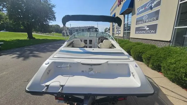Slide: The Image of 2001 Reinell 240 C boat parked outside a dealership on a sunny day. - 5