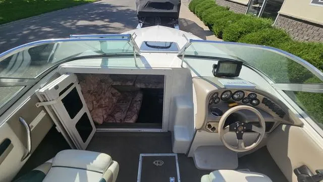 Slide: The Image of 2001 Reinell 240 C boat interior with steering wheel, dashboard, and cabin entrance. - 19