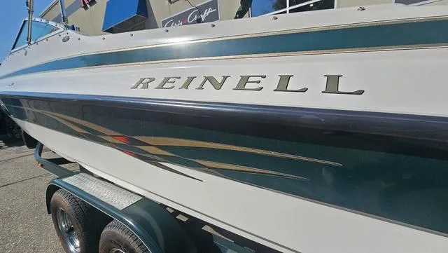 Slide: The Image of 2001 Reinell 240 C boat on trailer, featuring sleek design and bold graphics. - 24