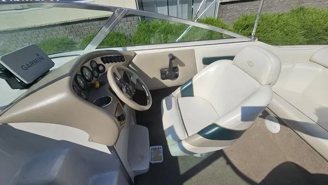 Slide: The Image of 2001 Reinell 240 C boat interior with steering wheel and Garmin navigation system. - 9