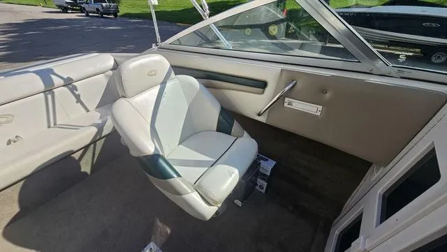 Slide: The Image of 2001 Reinell 240 C boat interior with white and gray seating, sunny day. - 8