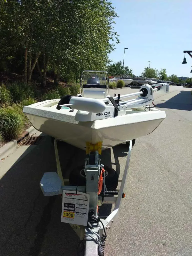 Slide: The Image of 2024 Ranger RB200 boat on trailer, parked outdoors. - 2