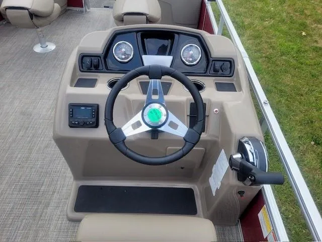 Slide: The Image of 2024 Ranger Reata 200F boat dashboard with steering wheel and controls. - 3