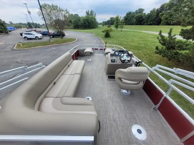 Slide: The Image of 2024 Ranger Reata 200F pontoon boat with spacious seating and modern controls. - 4