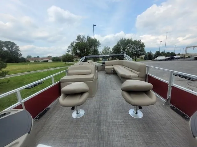 Slide: The Image of 2024 Ranger Reata 200F pontoon boat with spacious seating and modern design. - 5