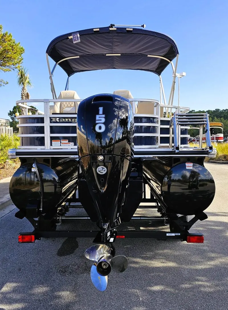 Slide: The Image of 2024 Ranger Reata 223F pontoon boat with powerful 150 HP engine, parked outdoors. - 4