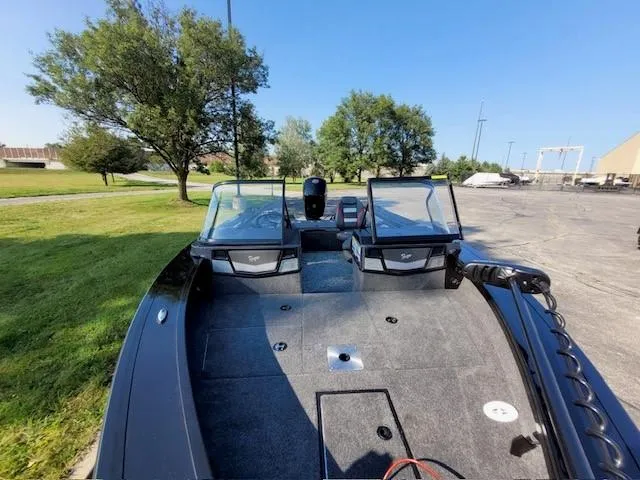 Slide: The Image of 2024 Ranger VX1788 WT boat with dual windshields, parked outdoors on a sunny day. - 4