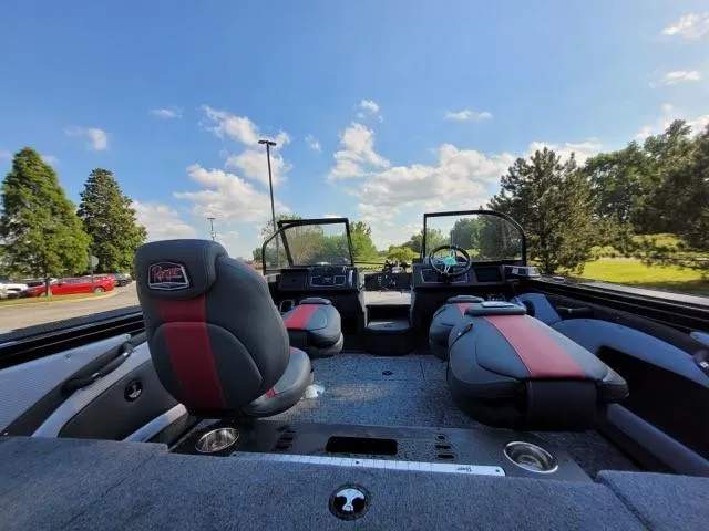 Slide: The Image of 2024 Ranger VX1788 WT boat interior with seating and dashboard, under a clear blue sky. - 5