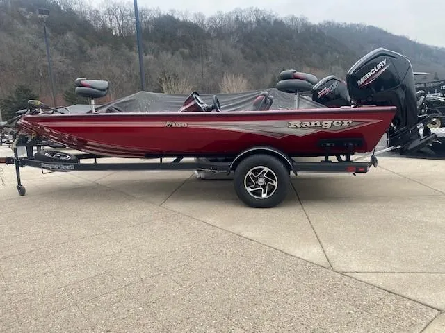 The Image of 2024 Ranger RT188 red fishing boat on trailer, parked outdoors. - 0