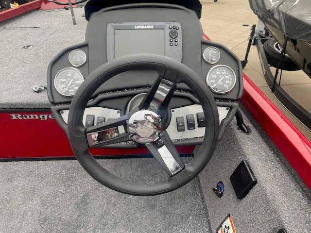 Slide: The Image of 2024 Ranger RT188 boat dashboard with steering wheel and Lowrance display. - 3