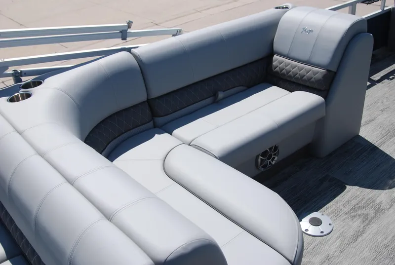 Slide: The Image of 2024 Ranger Reata 220F boat interior with plush gray seating and cup holders. - 12
