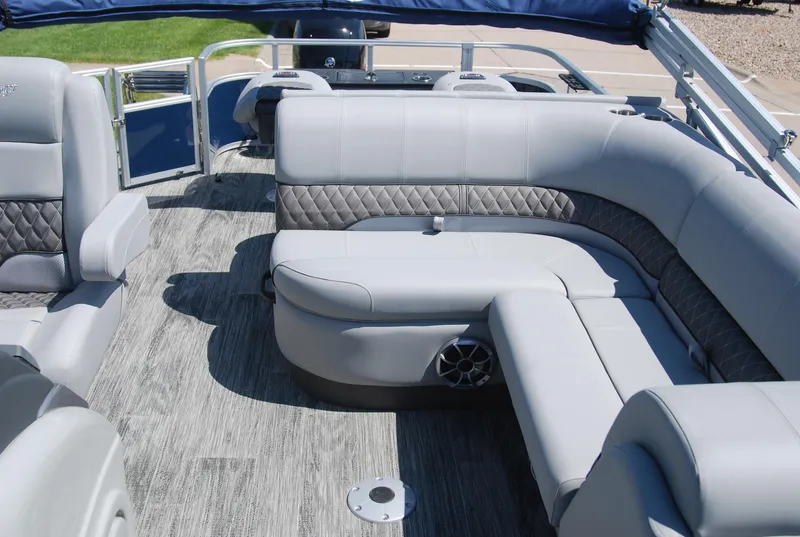 Slide: The Image of 2024 Ranger Reata 220F pontoon boat interior with plush seating and modern design. - 6