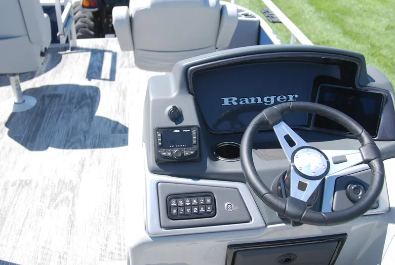 Slide: The Image of 2024 Ranger Reata 220F boat dashboard with steering wheel and control panel. - 7