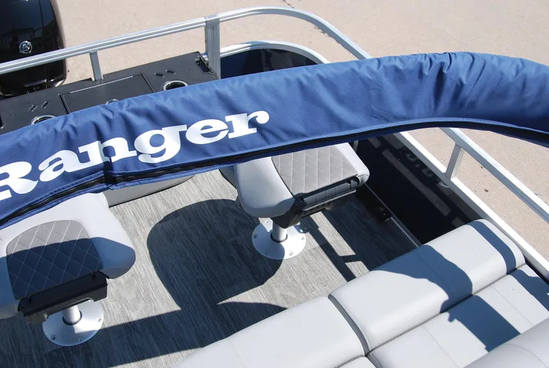 Slide: The Image of 2024 Ranger Reata 220F boat interior with seating and blue cover. - 9