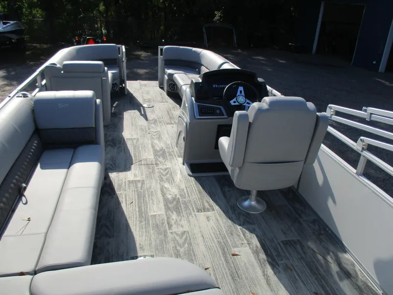 Slide: The Image of 2024 Ranger Reata 220C pontoon boat with spacious seating and modern interior design. - 4