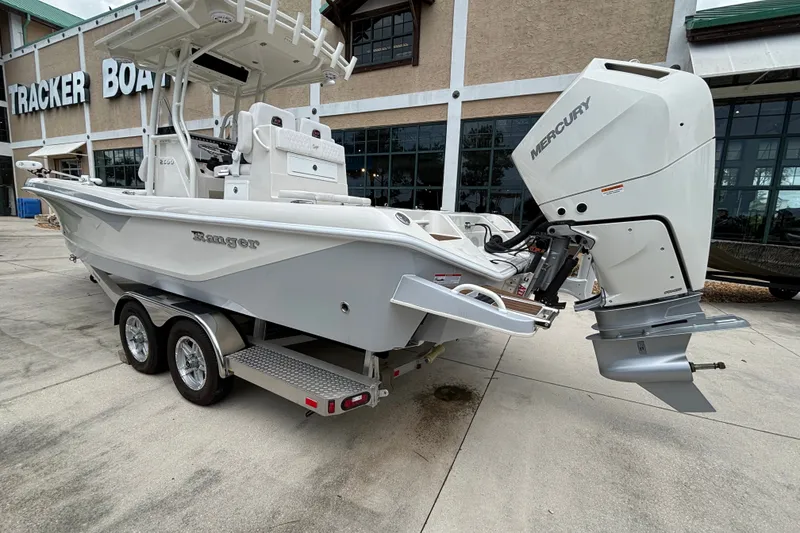 Slide: The Image of 2024 Ranger 2600 Bay boat with Mercury engine on trailer outside dealership. - 4